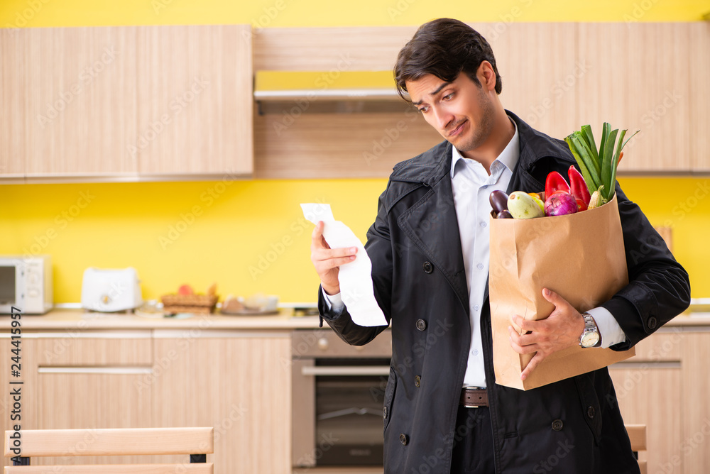 Young handsome man with vegetables in kitchen Young handsome man with vegetables in kitchen