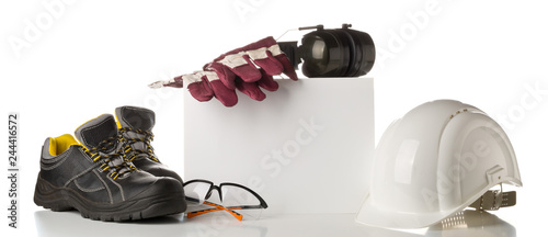Work safety and protection equipment - protective shoes, safety glasses, gloves and hearing protection over white