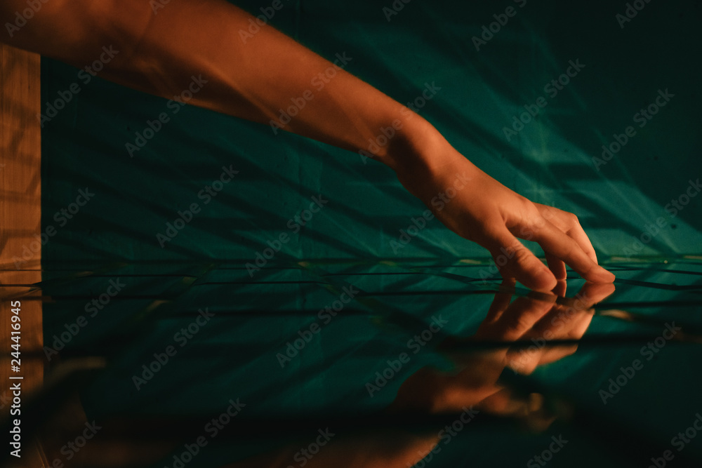 Female hand touching stylized designer brick glass wall