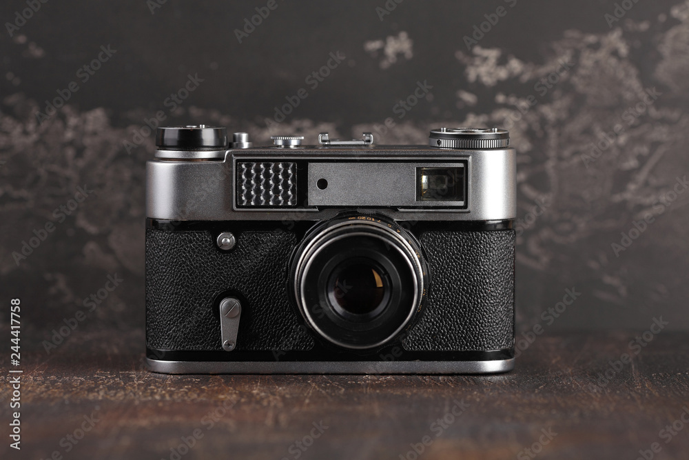 The old rangefinder camera on a brown cement background.