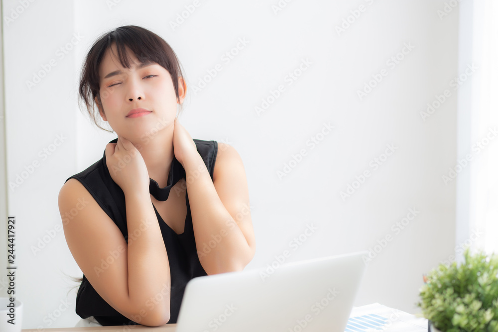 Business woman overwork on laptop computer and neck pain with at work in office, girl stress and illness chronic with office syndrome, health and emotion concept. Business woman overwork on laptop computer and neck pain with at work in office, girl stress and illness chronic with office syndrome, health and emotion concept.