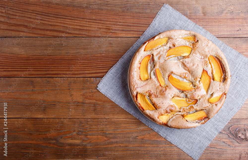 Sweet persimmon pie on brown wooden background.