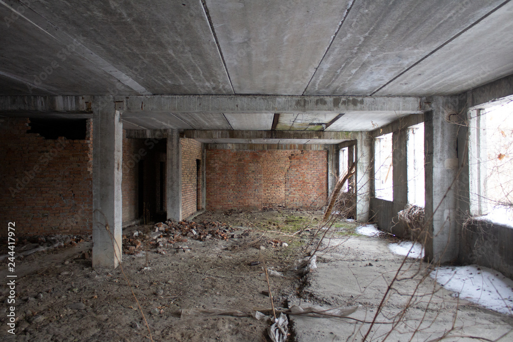 Neglected ruins of unfinished corps of building of plant..