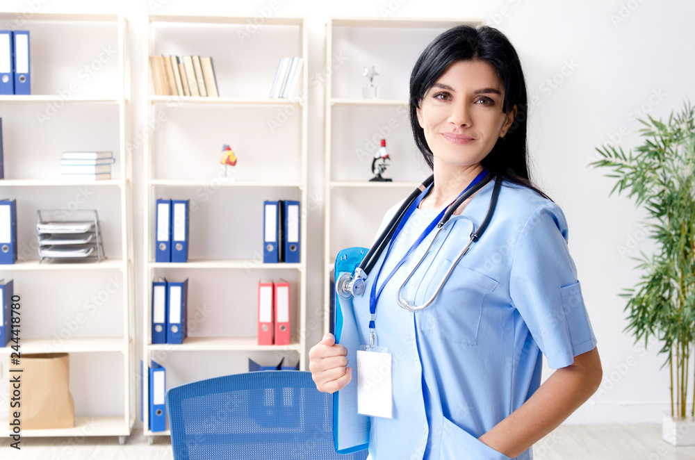 Middle aged female doctor working at the clinic Middle aged female doctor working at the clinic