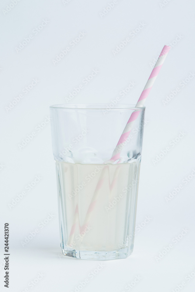 Fresh coconut water in transparent glass with straw. Fresh coconut water in transparent glass with straw.
