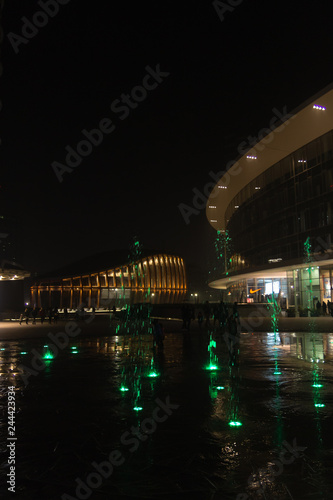 Milan, Italy, Financial district night view. Illuminated water fountains