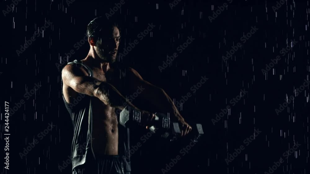 Athletic man working out in the rain. Slow Motion. Athletic man working out in the rain. Slow Motion.