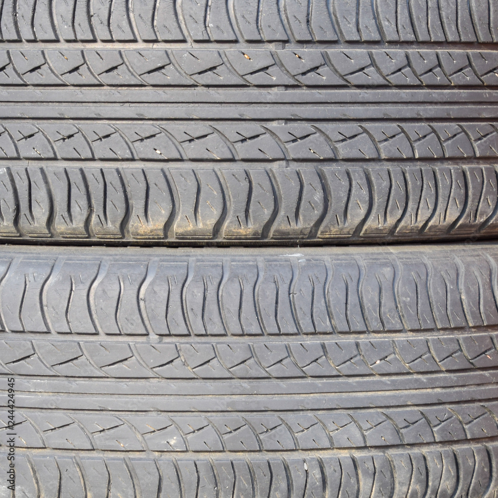 The background of the tread pattern of the car wheel. Rubber tir