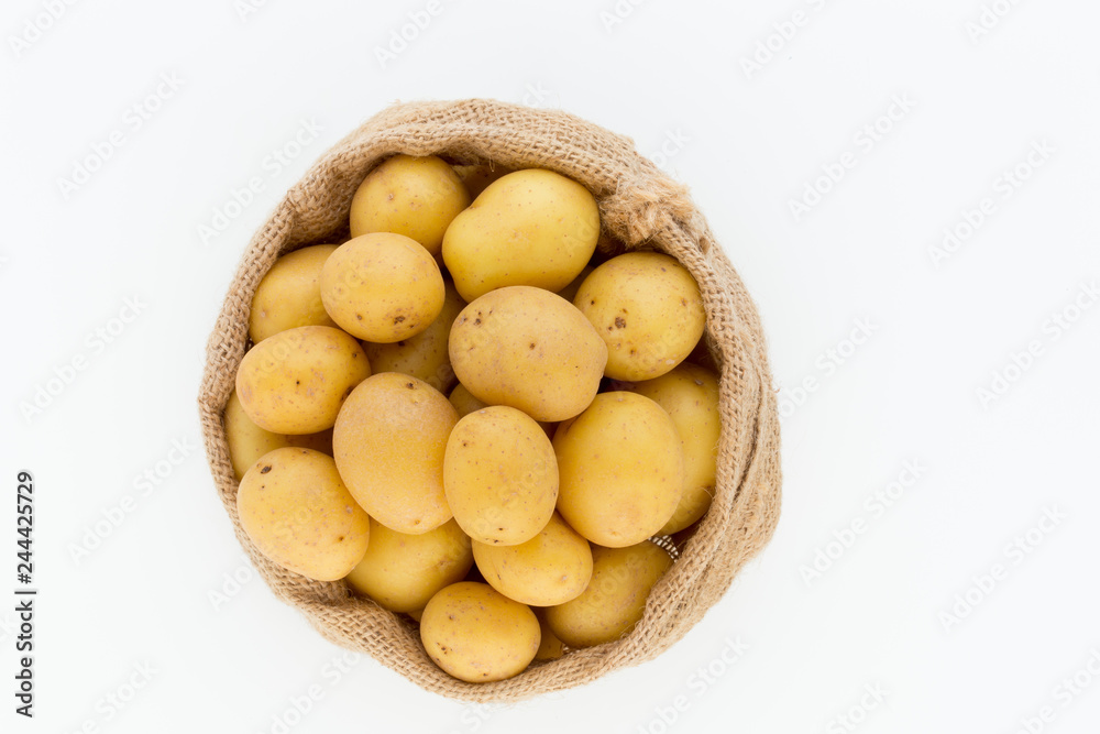 Sack of fresh raw potatoes on wooden background, top view Sack of fresh raw potatoes on wooden background, top view