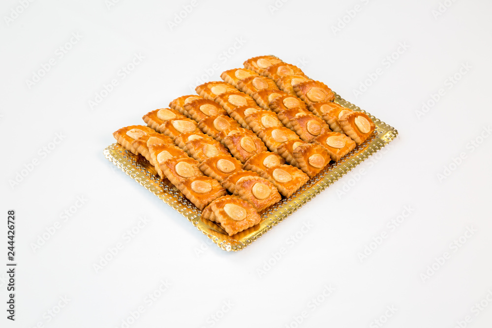 almond cookies on a gold tray with white background almond cookies on a gold tray with white background