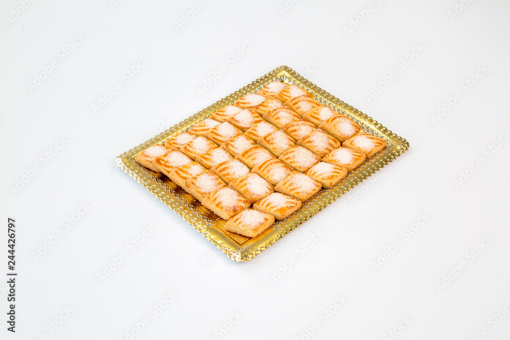 cookies on a gold tray with white background cookies on a gold tray with white background