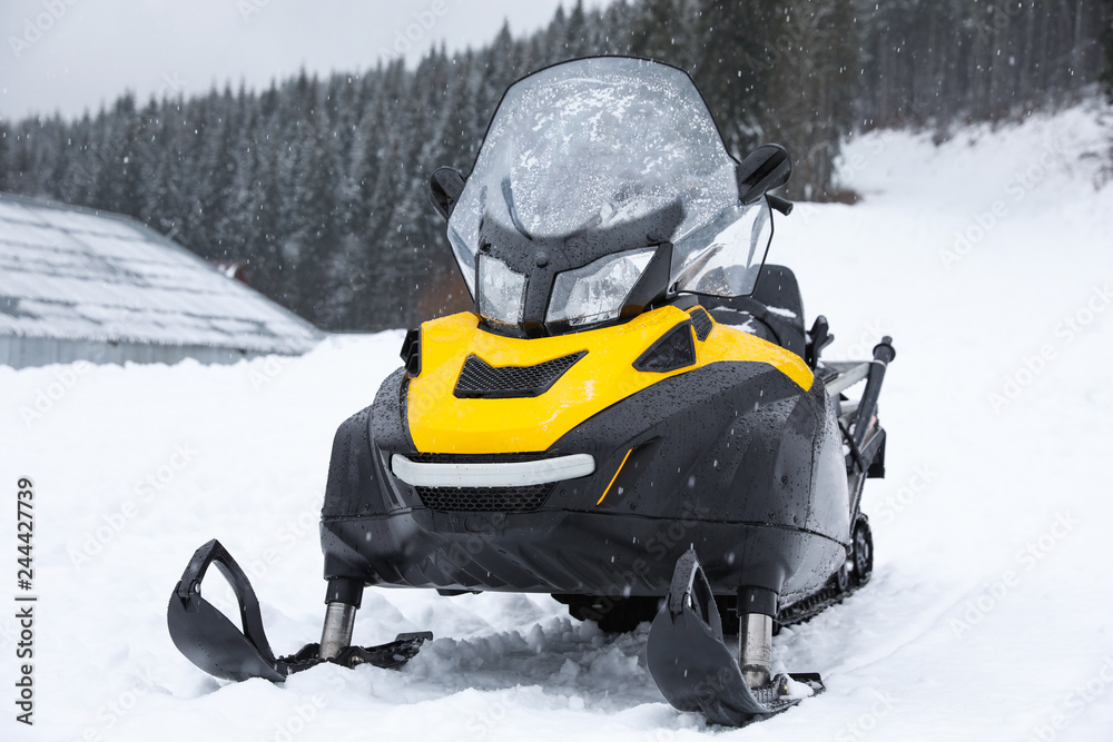 New stylish snowmobile parked outdoors. Winter recreation
