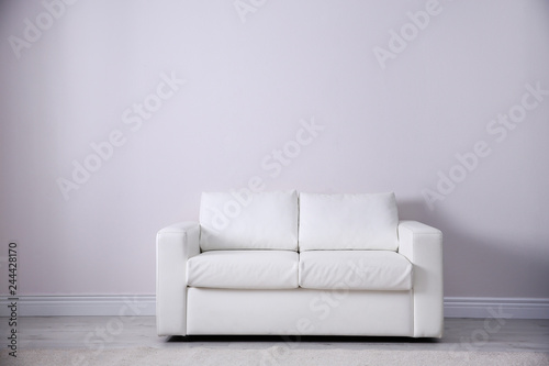 Bilde på lerret Simple living room interior with comfortable sofa near white wall