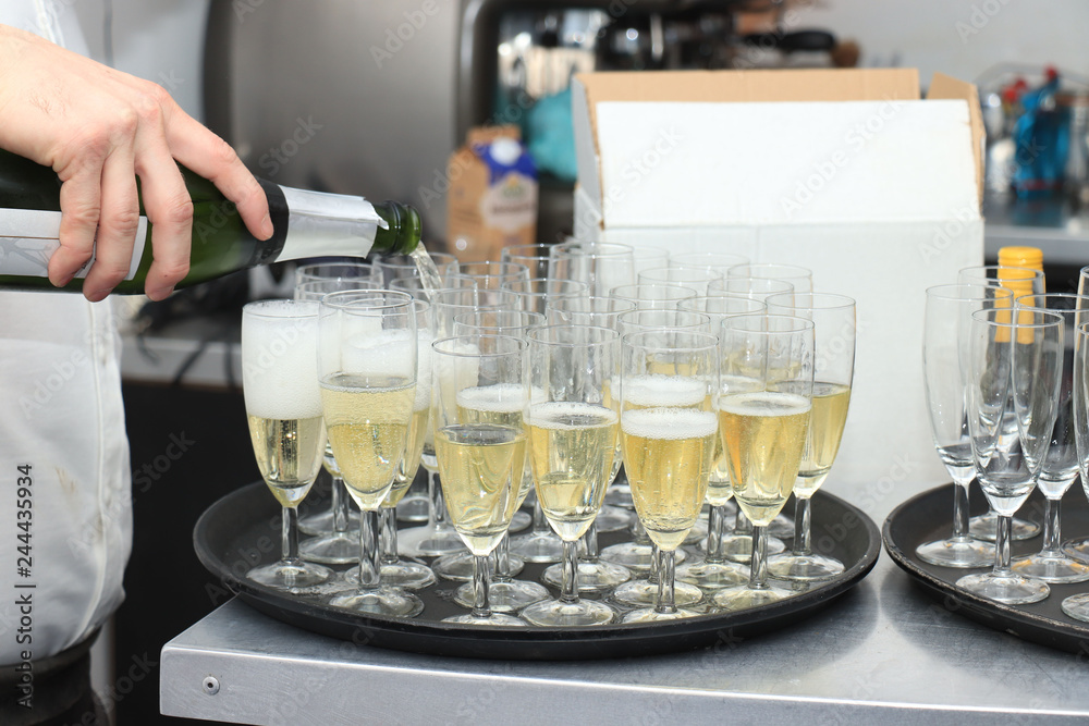 Pouring champagne in stylish glasses