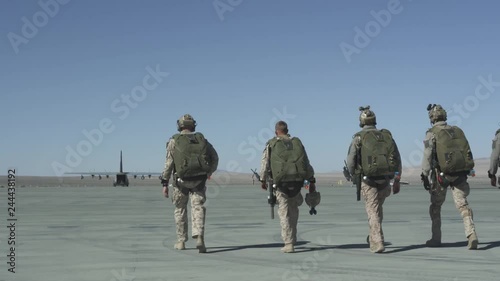 Slow motion of soldiers preparing to board military plane