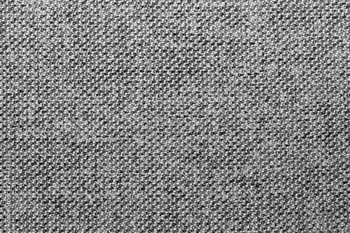 Gray and black mixed fabric texture or background, wool, tweed, melange cloth, closeup