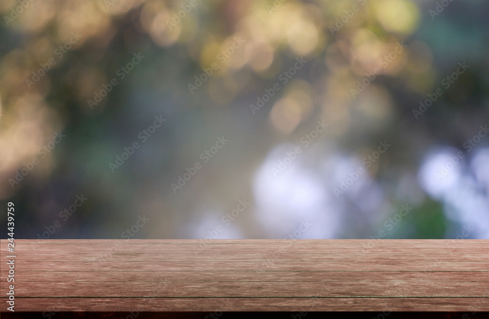 Empty wooden table in front of abstract blurred green of garden and trees background. For montage product display or design key visual layout - Image.