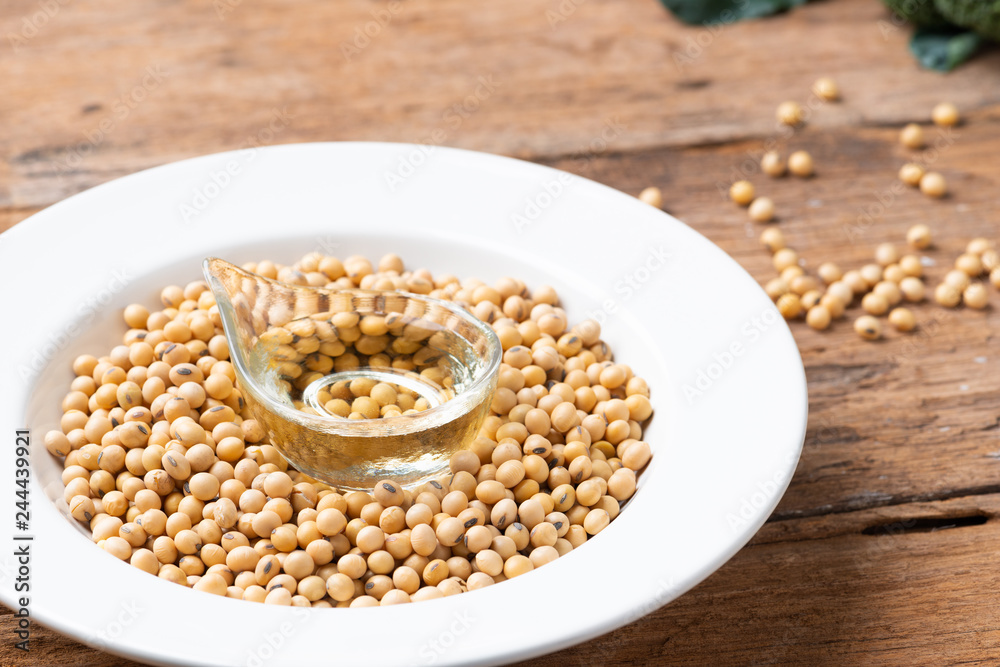 Soy bean and soy oil on table Soy bean and soy oil on table