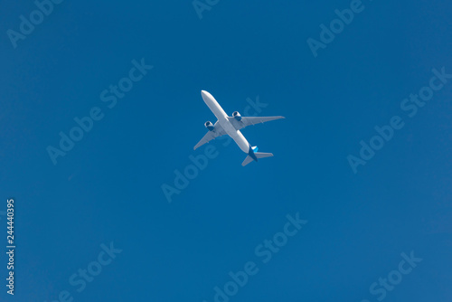 a plane flying in the blue sky