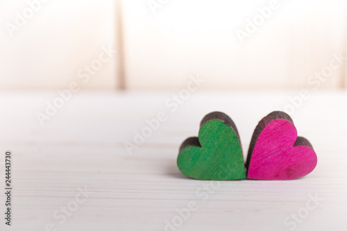 A colorful hearts on a wooden background