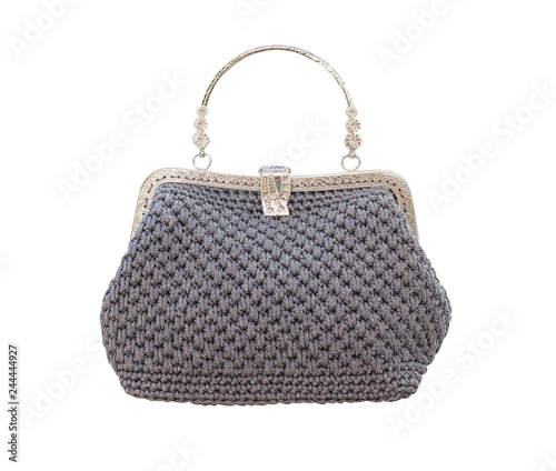 Gray crochet knitted hand bag and decoration with steel handle isolated on white background with clipping path , handmade patterns