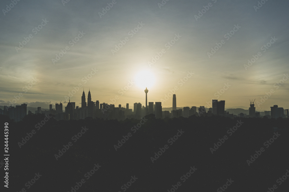 Cloudy sunrise over silhouette of downtown Kuala Lumpur, Malaysia.
