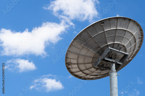 communication satellite dish on bright and blue sky background, Technology and communication concept.