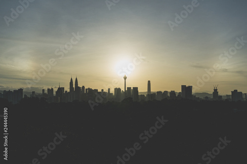 Cloudy sunrise over silhouette of downtown Kuala Lumpur, Malaysia.