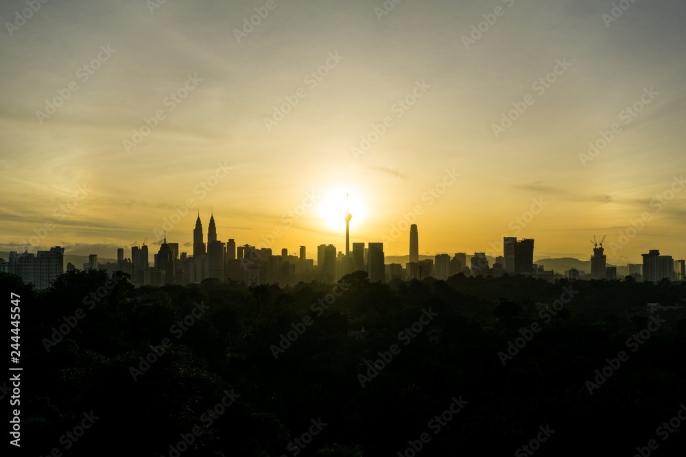 Cloudy sunrise over silhouette of downtown Kuala Lumpur, Malaysia. Cloudy sunrise over silhouette of downtown Kuala Lumpur, Malaysia.