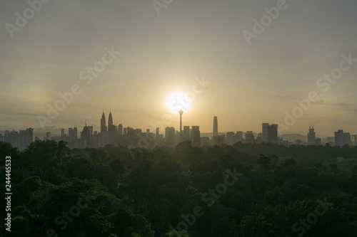 Photography Cloudy sunrise over silhouette of downtown Kuala Lumpur, Malaysia