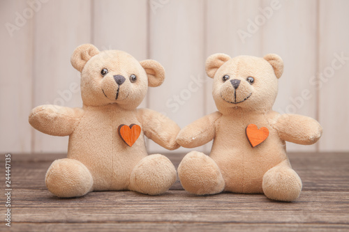Couple Teddy Bears on wooden background. Valentines Day card. Love heart. © Vladimir Badaev