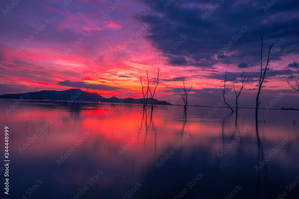 The close-up nature view of the secret light of the sky on the lake behind the mountain and the trees extending in the basin and reflecting, with natural beauty, colorful sky wallpaper The close-up nature view of the secret light of the sky on the lake behind the mountain and the trees extending in the basin and reflecting, with natural beauty, colorful sky wallpaper