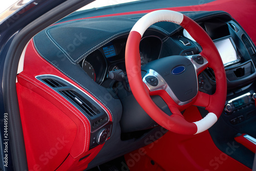 Car dashboard. Car interior details. Red and black alcantara with stitching photo