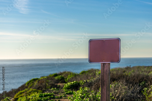 Empty sign plate, close up, ocean background