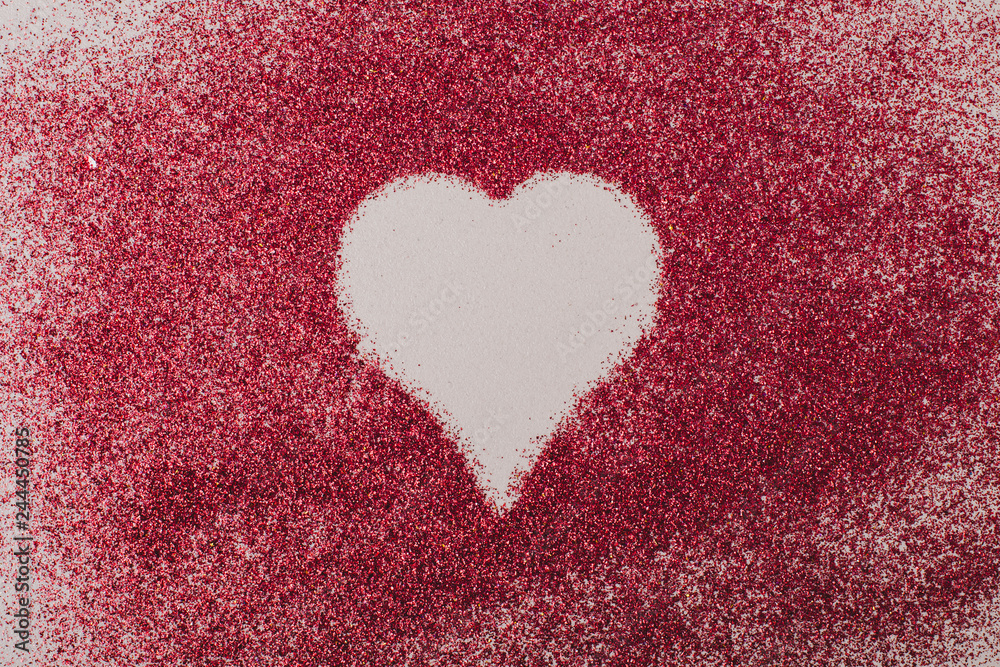 Symbol of heart between red grains Symbol of heart between red grains
