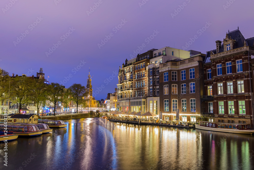 Amsterdam Netherlands, night city skyline at canal waterfront