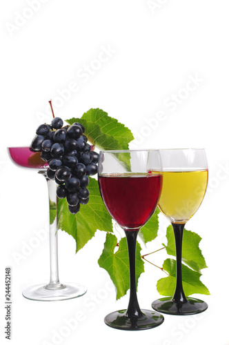 Two glasses of red and white wine and a bunch of grapes in a vase. Isolated on white