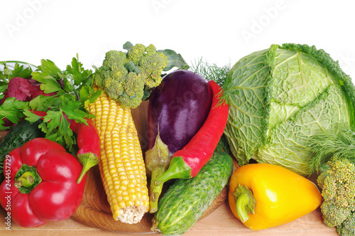 Vegetables on a white background. Cabbage  cucumbers  tomatoes  peppers  corn  eggplant  onions  carrots