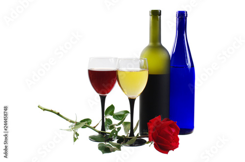 Two glasses of red wine, a bottle, a red rose and a bunch of grapes. Insulated on white