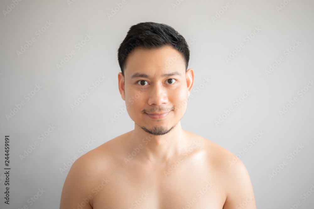 Smile Asian man in topless portrait isolated on gray background. Smile Asian man in topless portrait isolated on gray background.