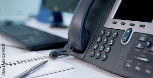 close up soft focus on telephone devices at office desk with light effect,communication technology concept	
