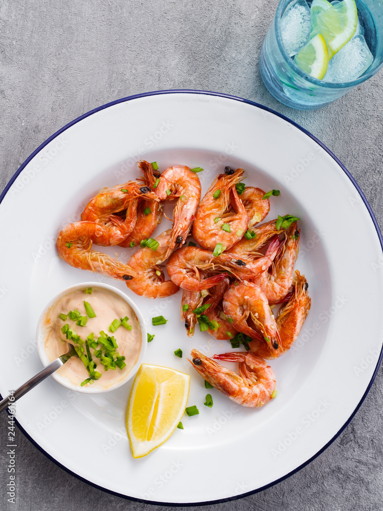 Shrimp glazed in soy sauce with green onion and lemon.