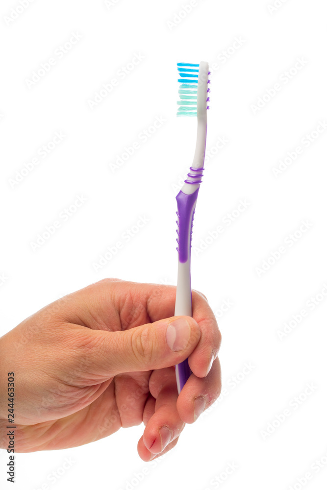 toothbrush in hand on an isolated background toothbrush in hand on an isolated background