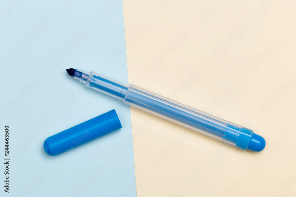 blue marker with cap on colour yellow and blue background. blue marker with cap on colour yellow and blue background.