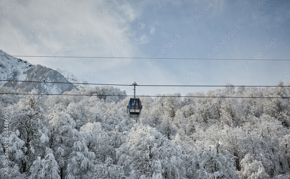 Fototapeta premium Cable cars on a background of mountains