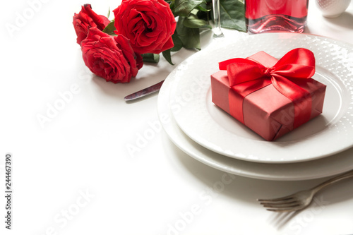 Valentine s day or birthday dinner. Elegance table setting with champagne and red rose.