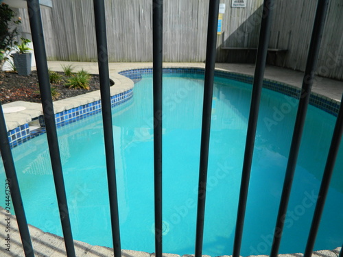 Swimming pool behind safety fence