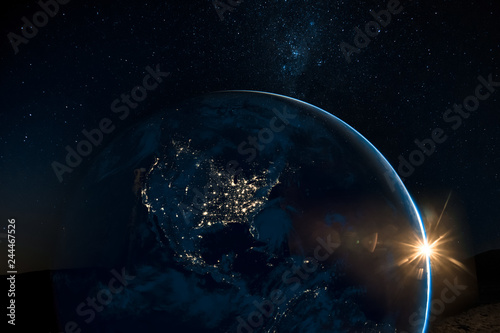 Fototapeta Naklejka Na Ścianę i Meble -  Night view of north America from the satellite to the glowing city lights on the sunrise from the east. Elements of this image are furnished by NASA.