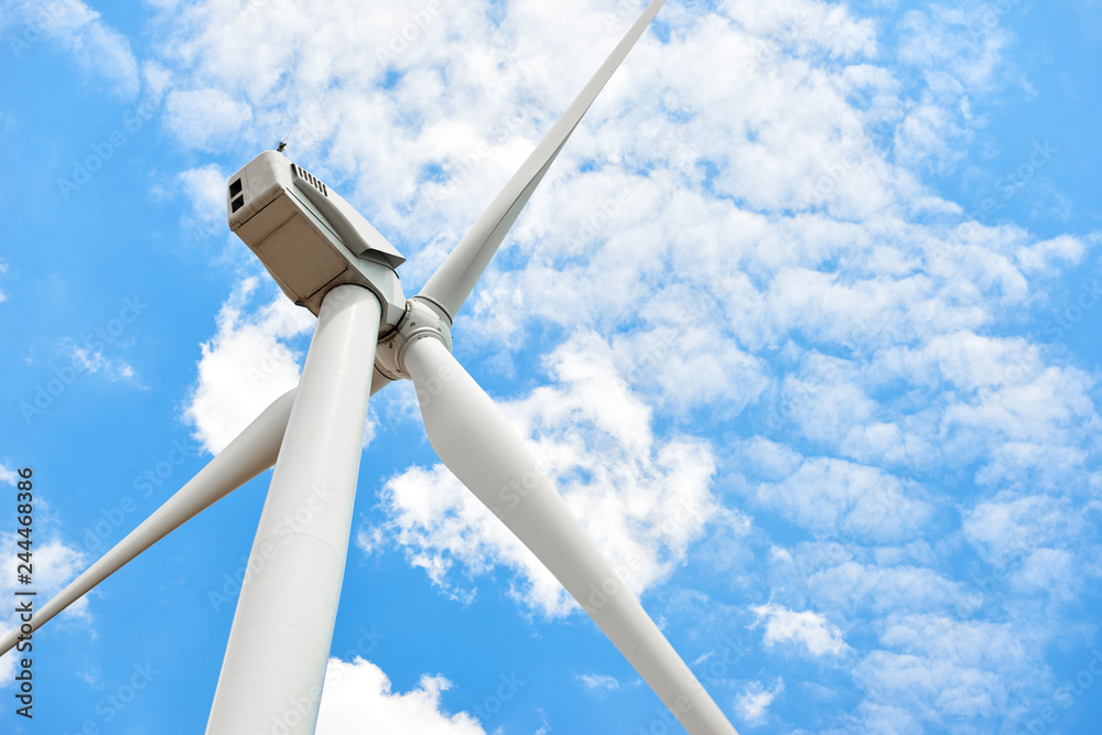 The wind generator is in bright cloudy sky. Eco energy concept. The wind generator is in bright cloudy sky. Eco energy concept.