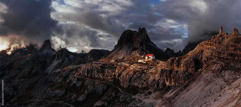 Nice landscape. Touristic buildings waiting for the people who wants goes through these majestic dolomite mountains. Panoramic photo